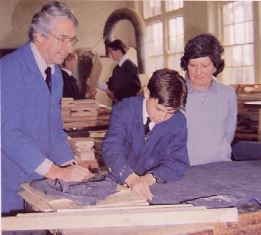 Rob Wells and Catherine Gray, daughter <br/>of the late Austin Gray, watch Wes Cordingley <br/>cut cloth for a chair at the Austin Gray Centre.